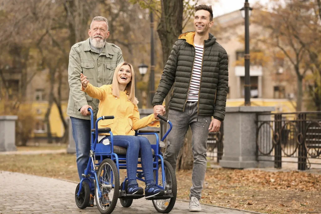 image of young woman in wheelchair surrounded by brother and father
